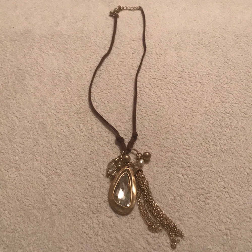 Adjustable necklace on leather strap.